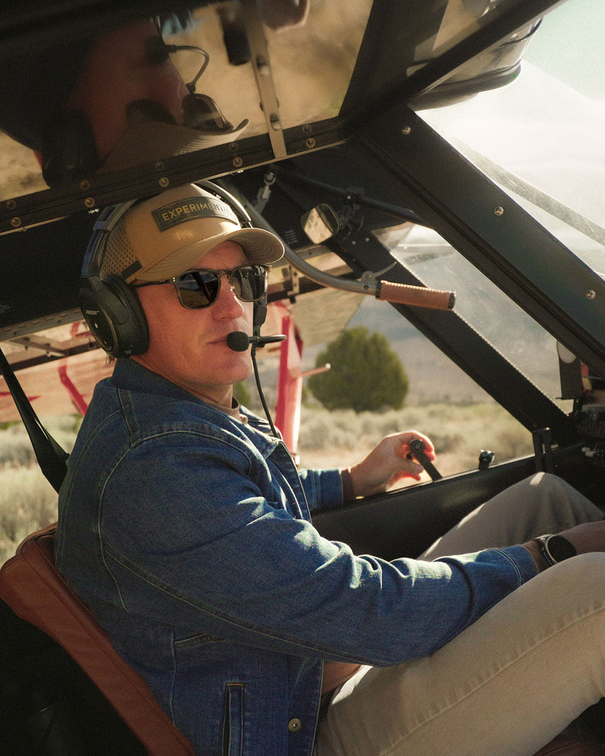 Trent Palmer wearing OTAVI sunglasses at the controls of a backcountry aircraft